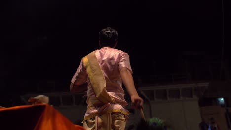 reveal shot of nighttime ceremony in varanasi