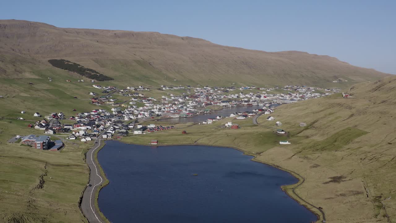 Panorama drone shot of Vagur town in The Valley on Suduroy island during sunny day - visiting Faroe Islands