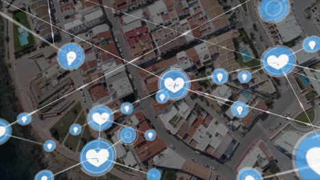 Social media interaction icons animation over aerial view of urban neighborhood