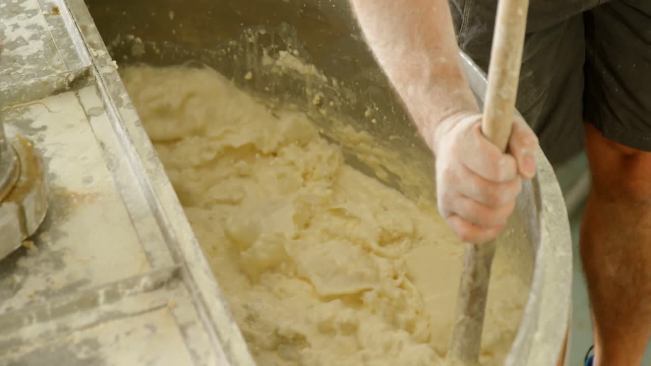 Male worker stirring gin in distillery 4k