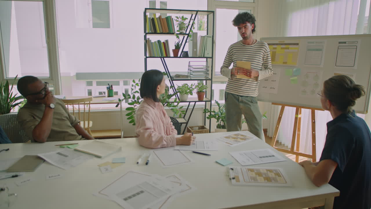 Young Male Student Talking by Whiteboard during Lesson