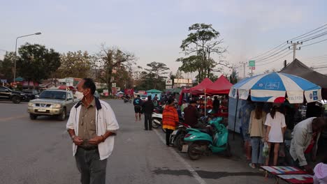 people shopping and walking in a busy market