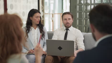 business meeting between two women and two men at an office 6