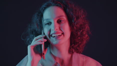 woman talking on phone with neon lighting
