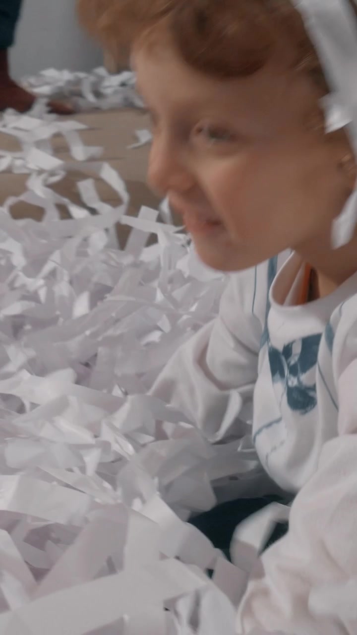 Little boy having good time at paper party