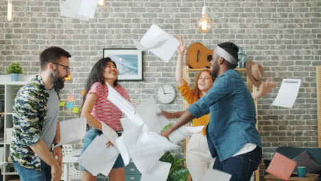 happy friends dancing in the office