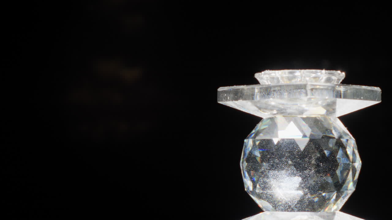 Rotating Prism Glass Jewel Turning On Right And Making Flashing Flares On Black