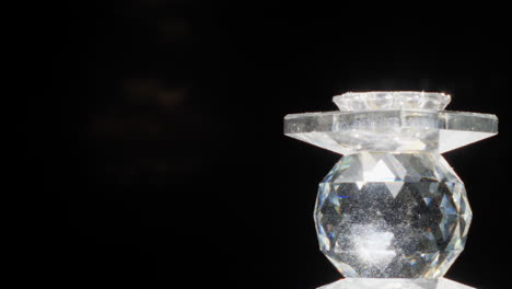 rotating prism glass jewel turning on right and making flashing flares on black