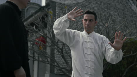 man practicing tai chi or qigong outdoors