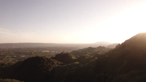 Aerial-landscape-view-of-the-sun-setting-over-the-famous-prosecco-hills-with-vineyard-rows,-in-the-italian-countryside