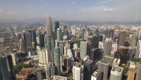 panning shot of kuala lumpur and petronas towers from the sky