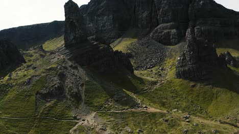 Drone-shot-flying-towards-and-tilting-up-to-reveal-The-Storr-in-Scotland's-countryside