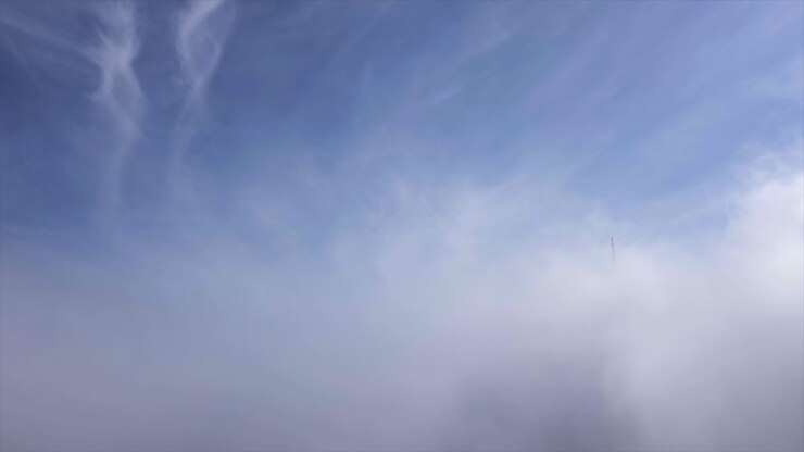 Aerial shot of broadcasting tower and wind generator over the black forest mountain Hornisgrinde