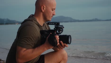 videographer on beach at sunset