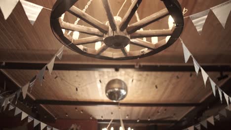 rustic country decor interior with wagon wheel chandelier and flags