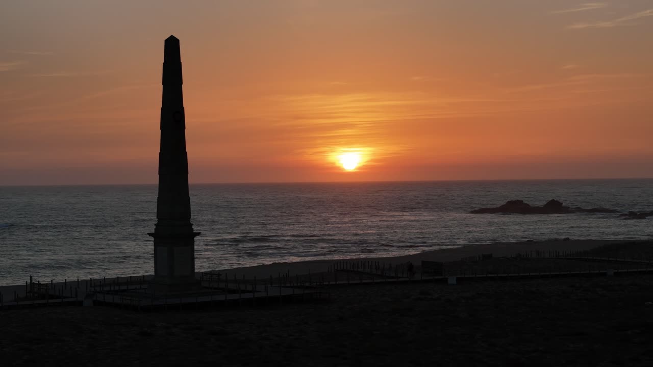 People enjoying the sunset on the boardwalk at Memoria beach