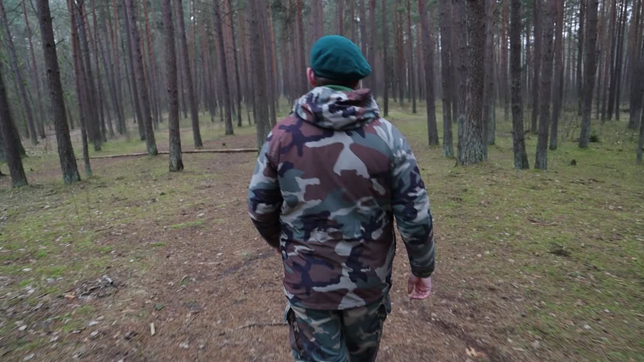 Back of a solder walking in the woods