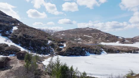 mountains and frozen lake during sunny day in palvatnet, tjern, osen norway