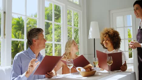 friends placing order to waitress