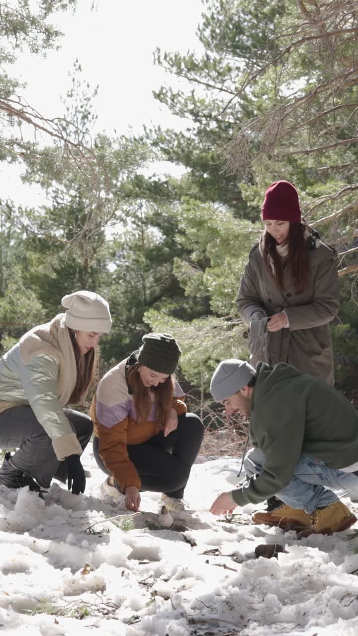 Group of friends enjoying a winter day in the forest