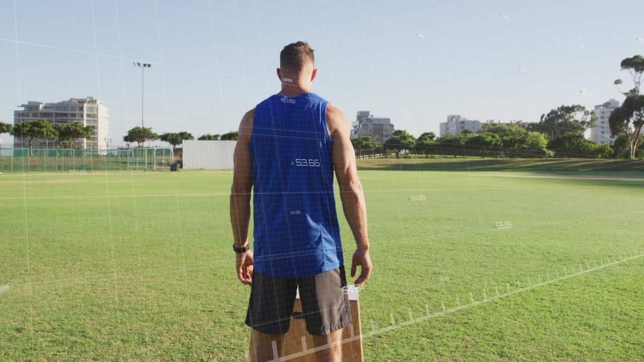 Man shifting weight jumping onto plyo box on turf landing then standing red graph tracking fitness