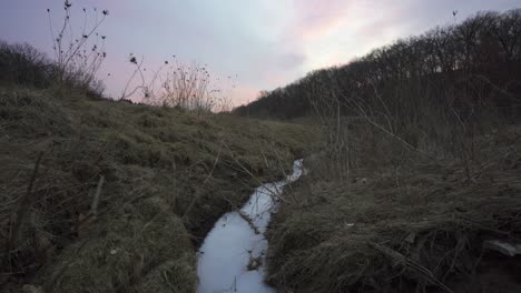 frozen creek in rural wisconsin.