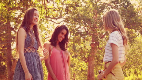 Pretty-blonde-woman-taking-pictures-of-her-friends-in-the-park