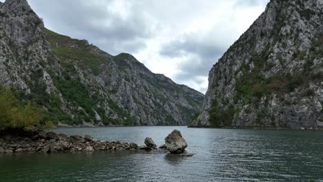 lake komani with rocky shores on drin river in shkoder, albania. wide shot