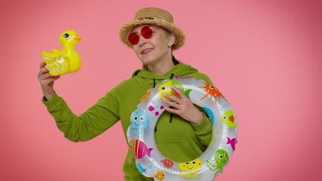 Cheerful senior old granny woman traveler tourist dancing fooling, vacation, journey trip to seaside