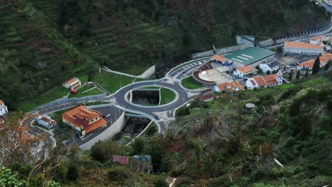 aerial view of a roundabout in a valley surrounded by mountains, madeira, portugal