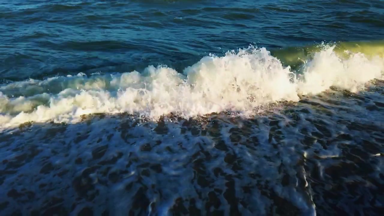 Sea wave at sunset. Slow motion.