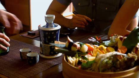 tray of sushi and drink on restaurant table