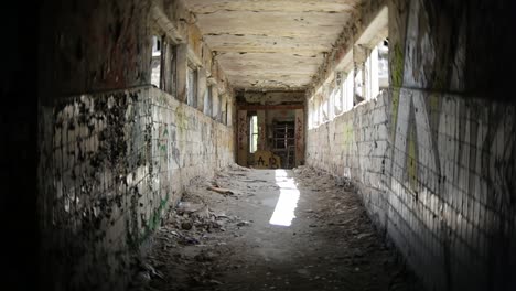 Destruction-and-debris-in-crumbling-halls,-abandoned-scary-place---urban-exploration