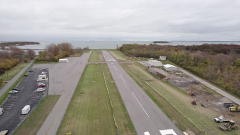 small plane taking off from runway on small rural airport in put in bay, ohio, usa