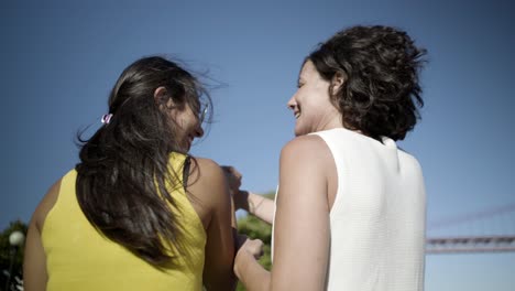 Back-view-of-happy-women-walking-outdoor