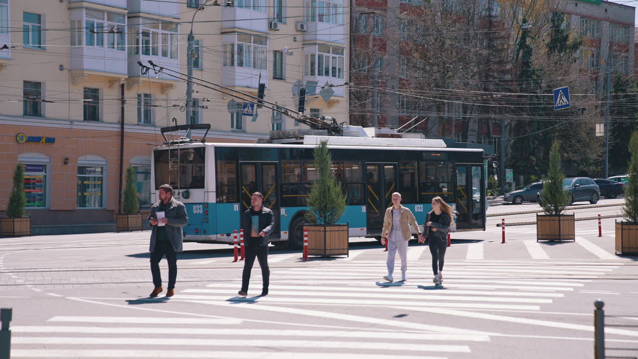 People crossing the street. View of young people crossing the street