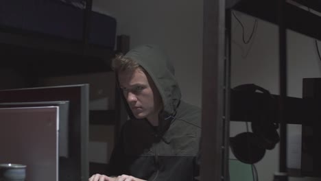 a steady shot of a hacker on a computer