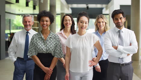 portrait of smiling multi-cultural business team inside modern office lobby