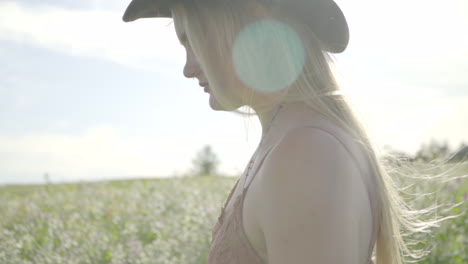 slomo of young woman walking in a field of flowers