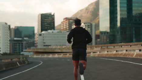 running, fitness and back of man in city