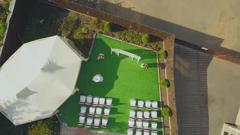 wedding-venue-with-flowers-near-tent-in-yard-aerial-view