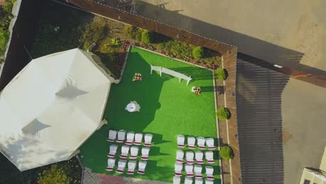 wedding venue with flowers near tent in yard aerial view