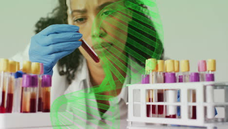 examining test tube, scientist with dna strand animation over laboratory scene