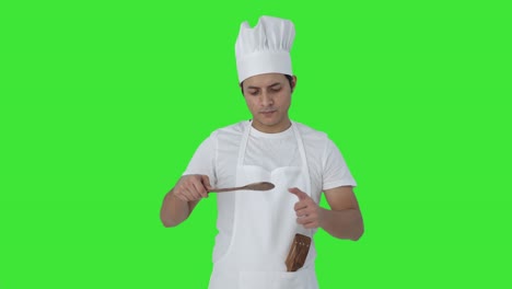happy indian professional chef tasting good food green screen