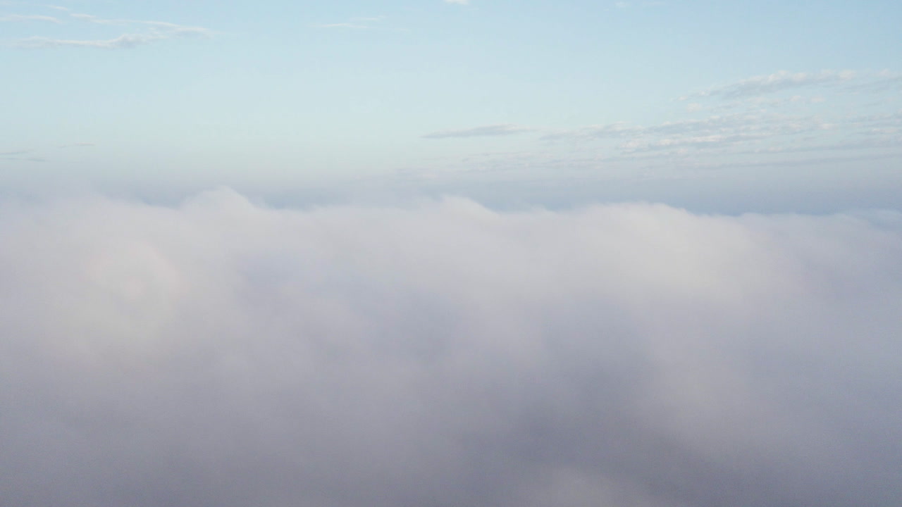 Cinematic drone shot above the clouds