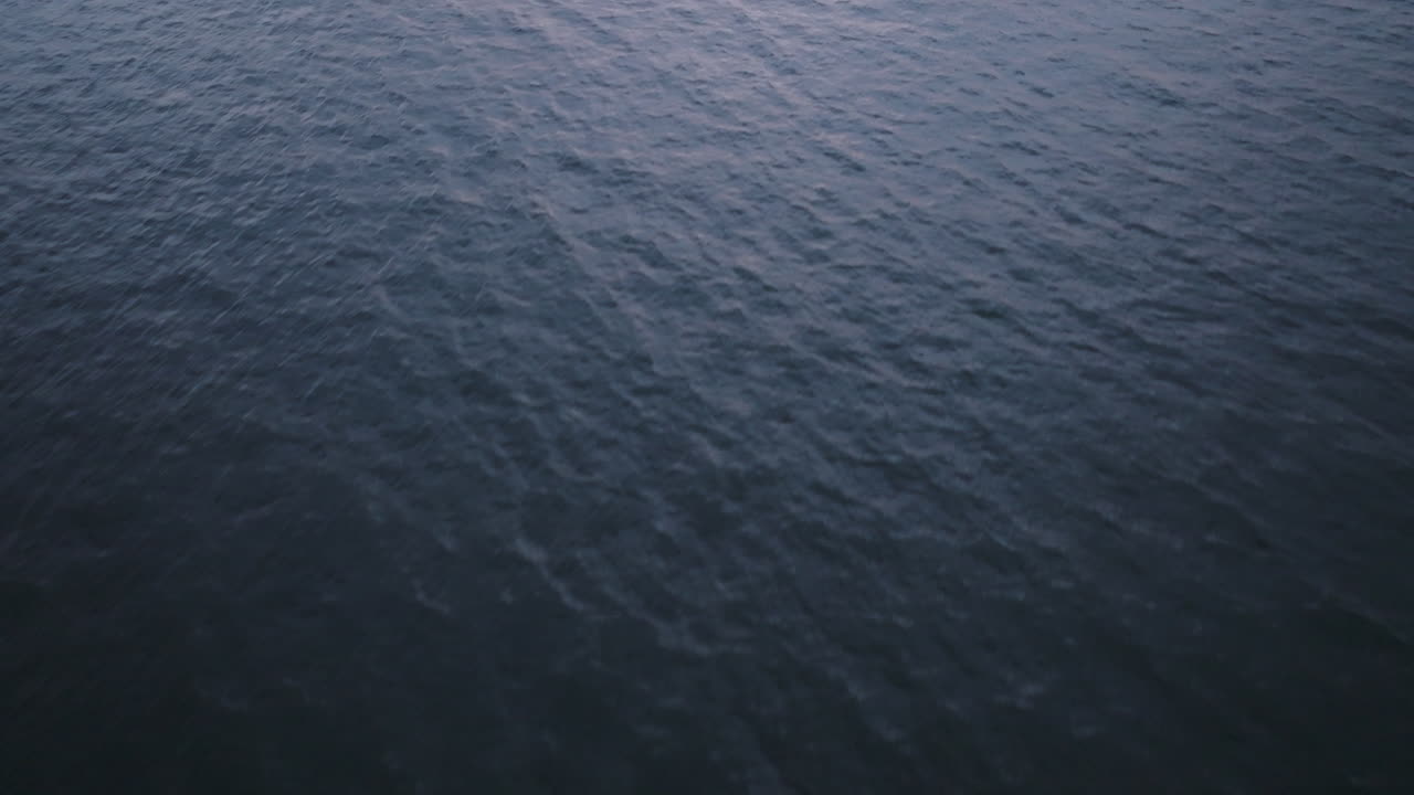 Aerial view of water in the ocean. Shot at dusk