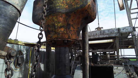 rotating borer at the site for oil production. close up. standing at the foot of a huge derrick drilling oil.