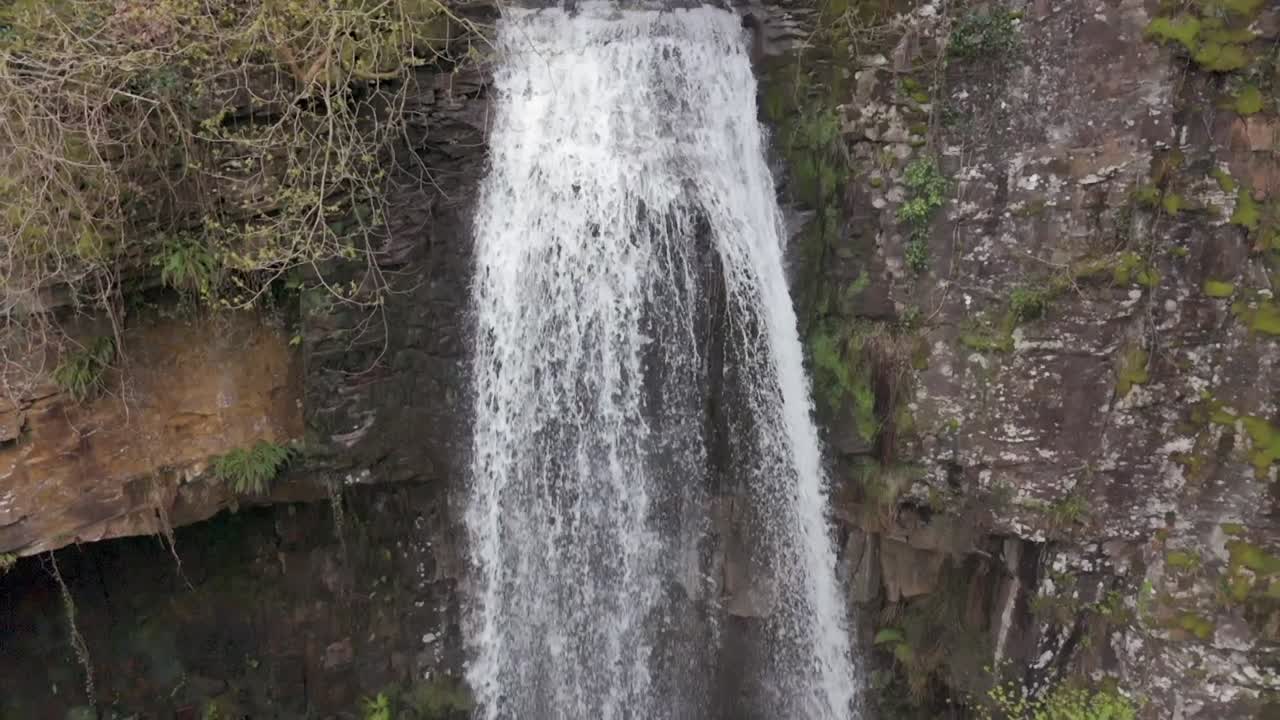 una vista aérea en cámara lenta de la cascada de melinclourt en un día nublado, cerca de port talbot, gales del sur