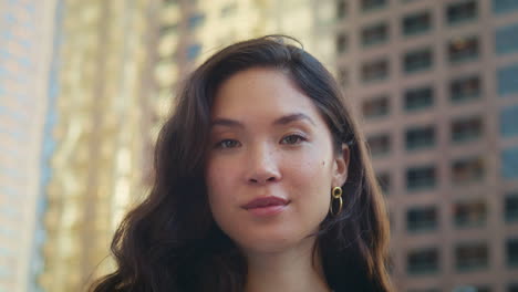 Asian-woman-taking-off-mask-on-town-street-closeup.-Concept-safety-healthy-life.