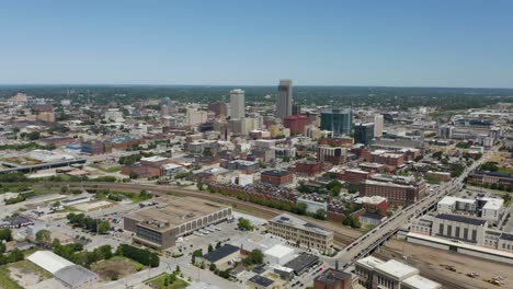 Aerial-Hyperlapse-Away-from-Downtown-Omaha,-Nebraska-on-Hot-Summer-Day